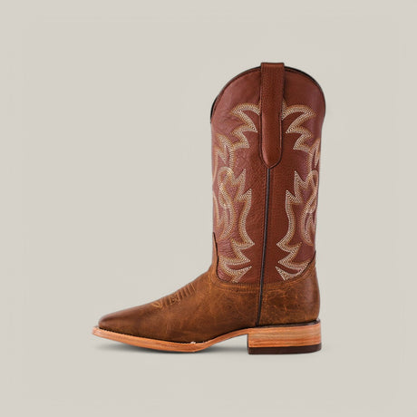 The Siberia Honey - Square Toe is a single brown cowboy boot featuring intricate stitching on the shaft, a square toe, slight heel, and pull straps. Crafted from premium leather, its shown in a side profile against a neutral background.