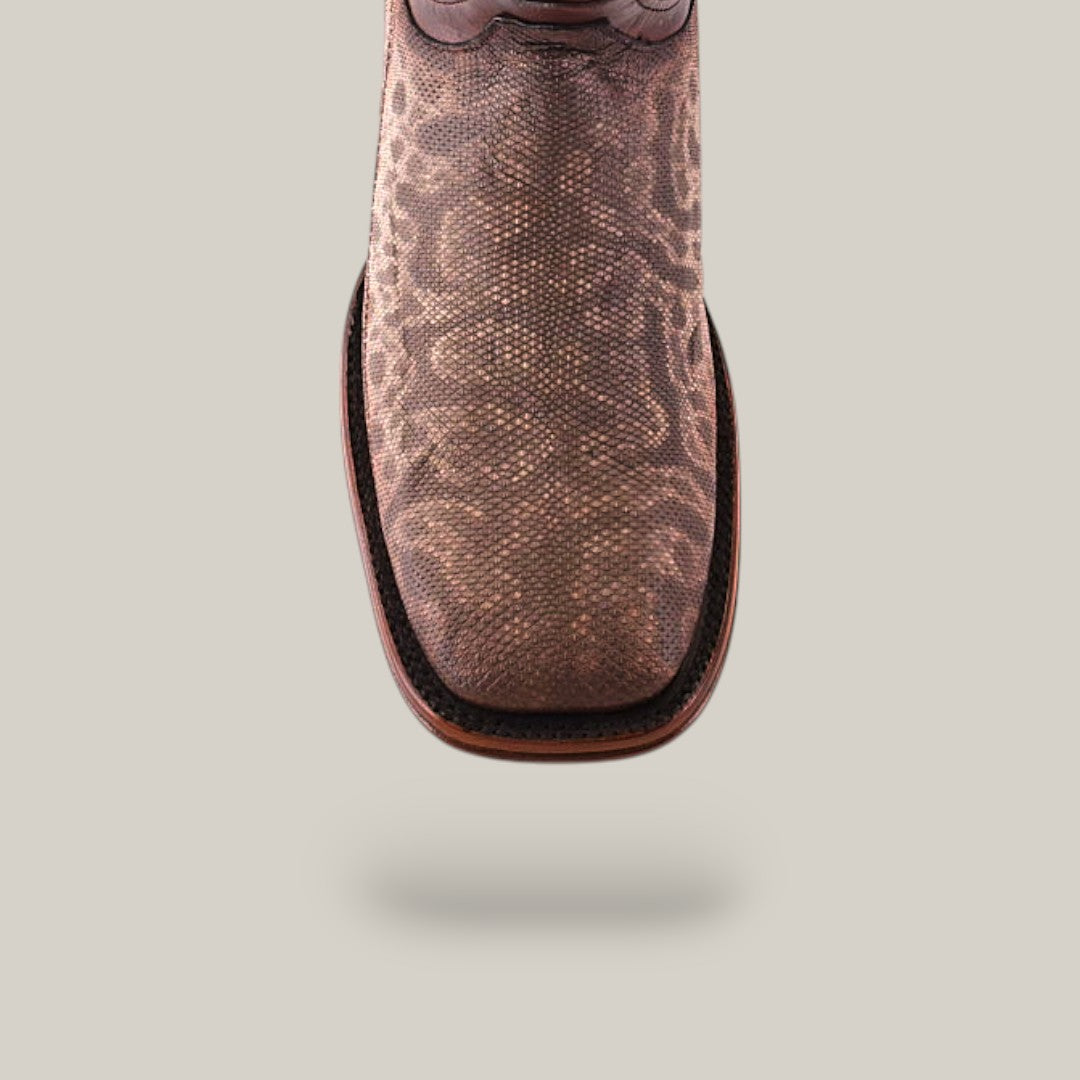 The Exotic Carunga - Diamond boot features a square toe with a patterned, reptile-like texture crafted from genuine exotic leather. The dark trim adds cowboy charm against the neutral background.