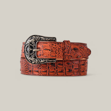 The Caiman Print Cogñac Belt, adorned with a detailed Texas buckle featuring star motifs, is elegantly coiled on a neutral background.
