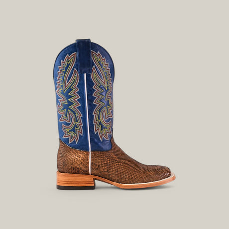 The Exotic Python - Tamarindo - Square Toe cowboy boot features textured brown leather and a tall blue shaft with colorful embroidery. Its modern square toe design and wooden heel add an exotic flair against the plain beige background.