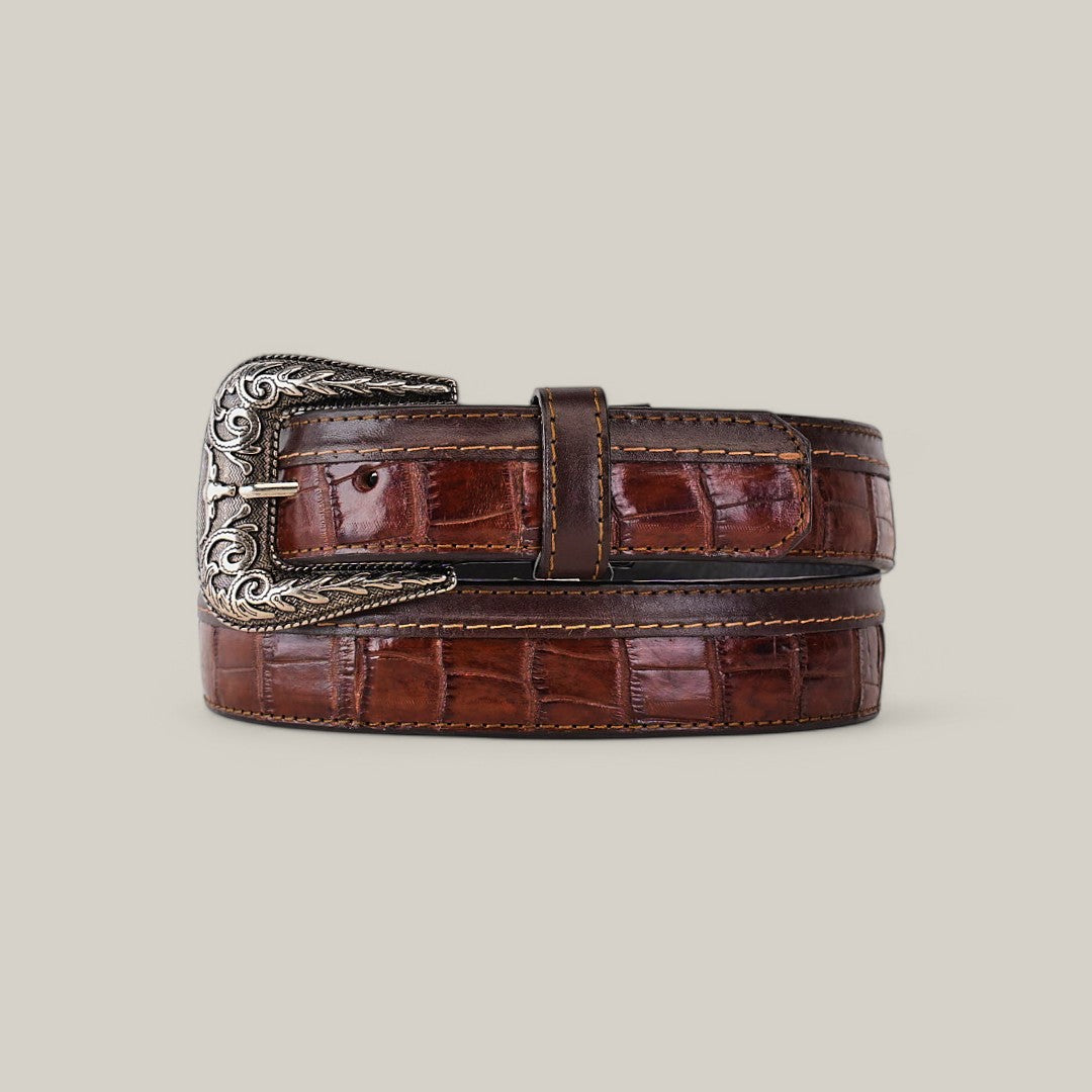 The Exotic Full Quilt Alligator Belt in brown, featuring a crocodile pattern and a platinum buckle with star engravings, is coiled on a plain background exuding elegance and style.