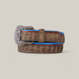 The Exotic Caiman - Platinum Buckle - Gray Belt features an elegant coiled design with a large, intricately engraved platinum buckle. Blue and red trims add flair against the light gray, making it a true luxury accessory.