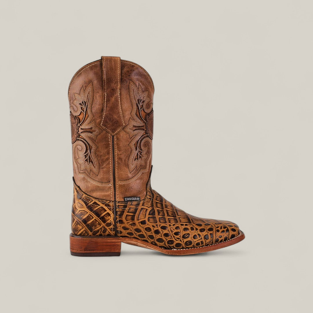 The Jonh - Orix - Square Toe is a premium leather cowboy boot with intricate dark embroidery on the shaft and a crocodile-patterned lower foot, displayed in profile against a plain light background.