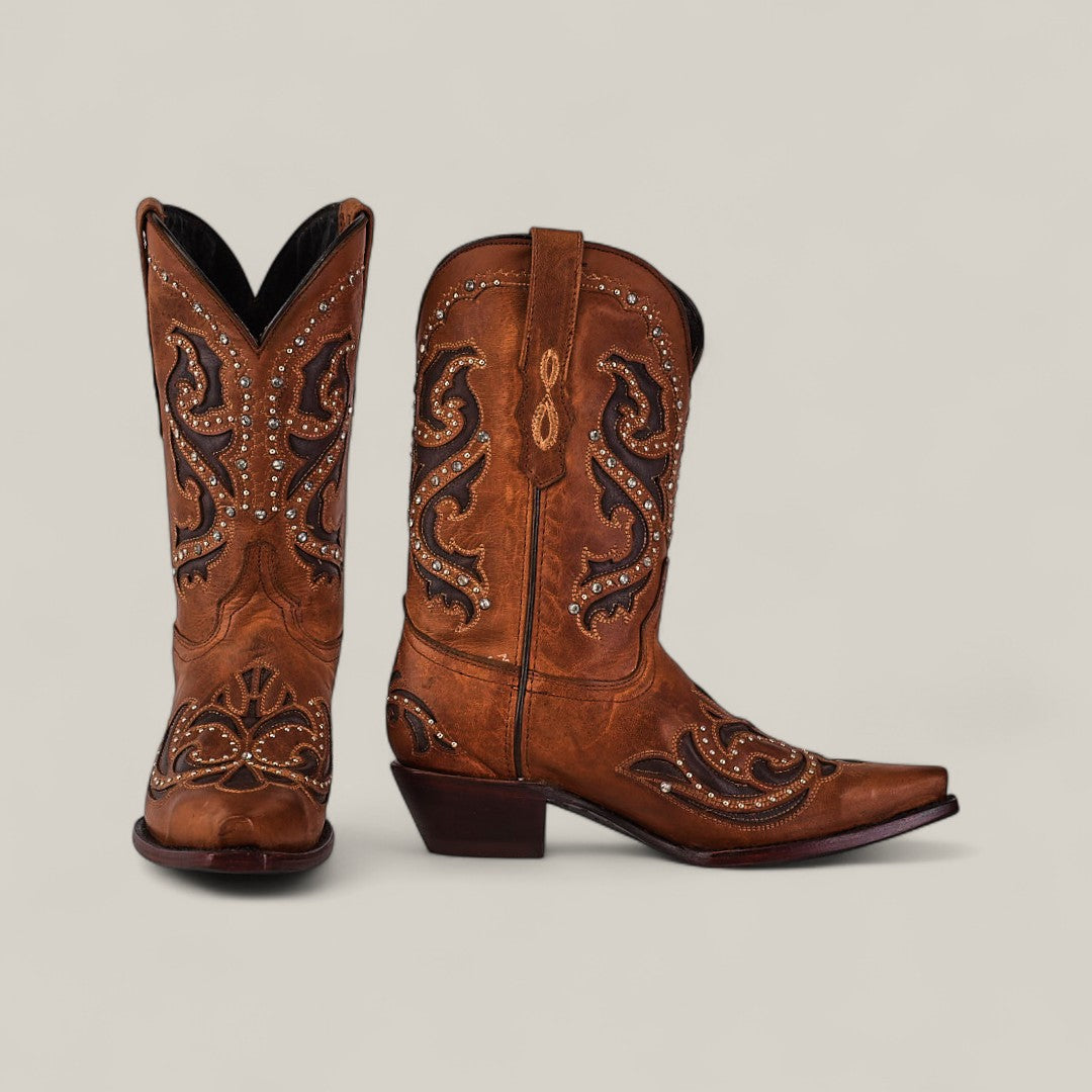 The Dolly - Brown - Snip Toe boots feature brown cowhide, intricate stitching, decorative patterns, and small metal studs from the Last Call collection, shown against a plain light background.