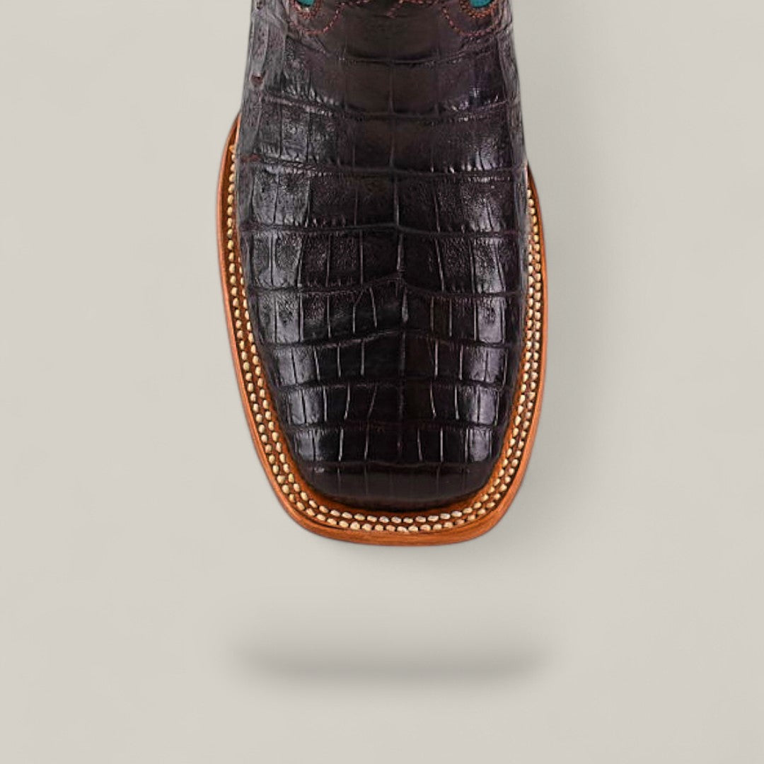 Top view of the Exotic Caiman Horn Back boot in dark brown, featuring a square toe, light brown trim, and decorative stitching.