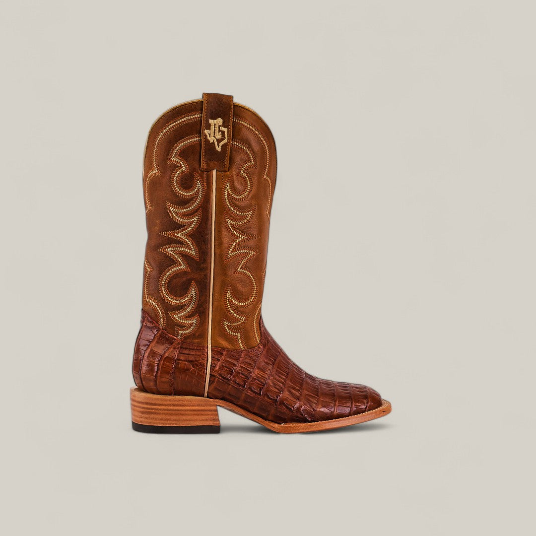 The Exotic Caiman Belly Tail - Brandy - Square Toe boot showcases a textured caiman belly lower, decorative stitched shaft, low heel, square toe silhouette, and a pull tab with embroidered logo against a light background.