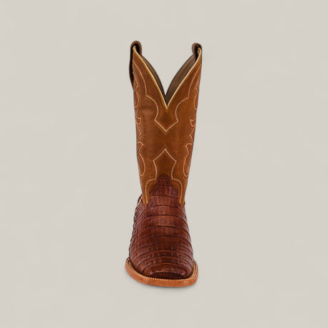 The Exotic Caiman Belly Tail - Brandy - Square Toe cowboy boot features decorative shaft stitching and a textured, dark Caiman Belly foot, displayed from the front on a plain, light background.