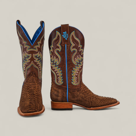A pair of Exotic Python - Tamarindo - Square Toe boots from the Platinum Collection, featuring brown textured leather, yellow and blue stitching, blue lining, and wooden heels. One boot stands upright; the other is angled forward on a light background.