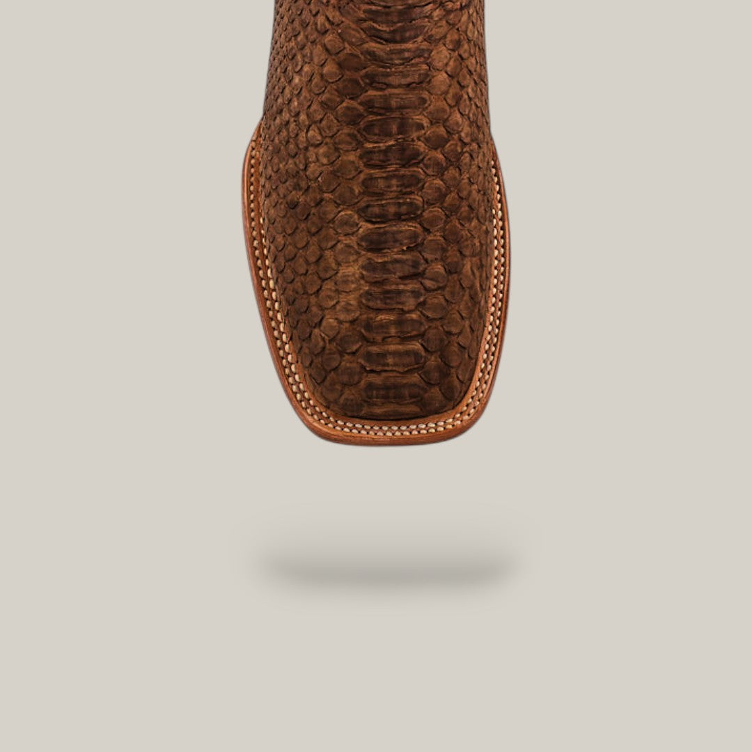 Close-up of the toe on the Exotic Python - Tamarindo - Square Toe boot, showcasing its python-like texture and intricate edge stitching, set against a plain light background.