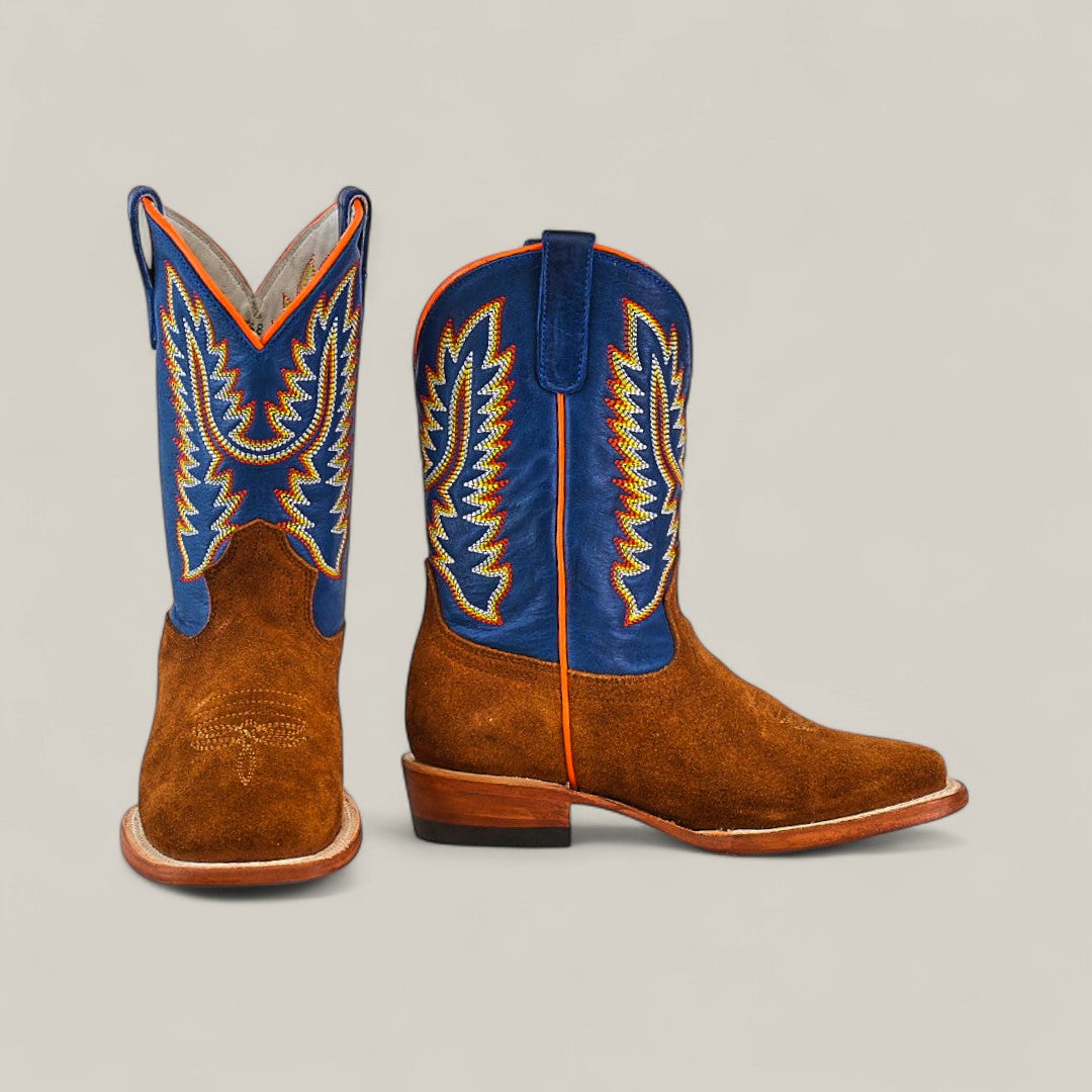 The Diamond Suede Ocre - Square Toe - Kids boots feature a brown suede foot, blue leather shaft, and yellow-orange wing-like stitching. One boot stands upright; the other faces forward.
