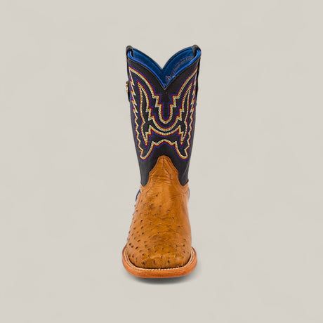 The Exotic Full Quilt Ostrich Fawn - Square Toe - Kids Boot features a fawn ostrich foot, dark blue shaft, and colorful embroidery, displayed from the front against a plain light background.