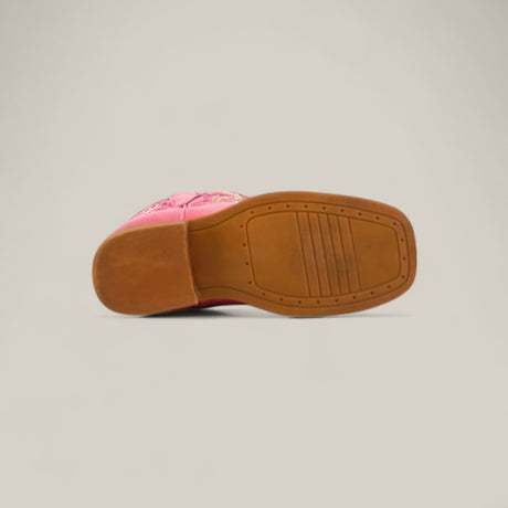 The image displays the bottom view of the Amara Pink - Square Toe - Kids Boots, showing a brown rubber sole with textured grip on a plain light beige background.