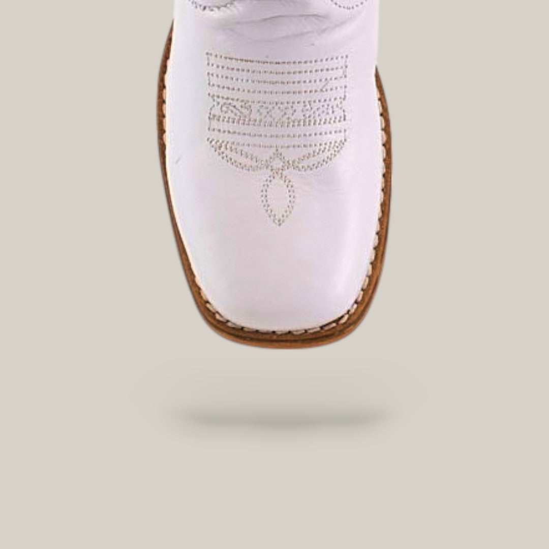 The Amara White Square Toe Kids Boots feature premium white leather, brown stitching, and decorative toe patterns—an elegant blend of style and comfort, shown from above against a light gray background.