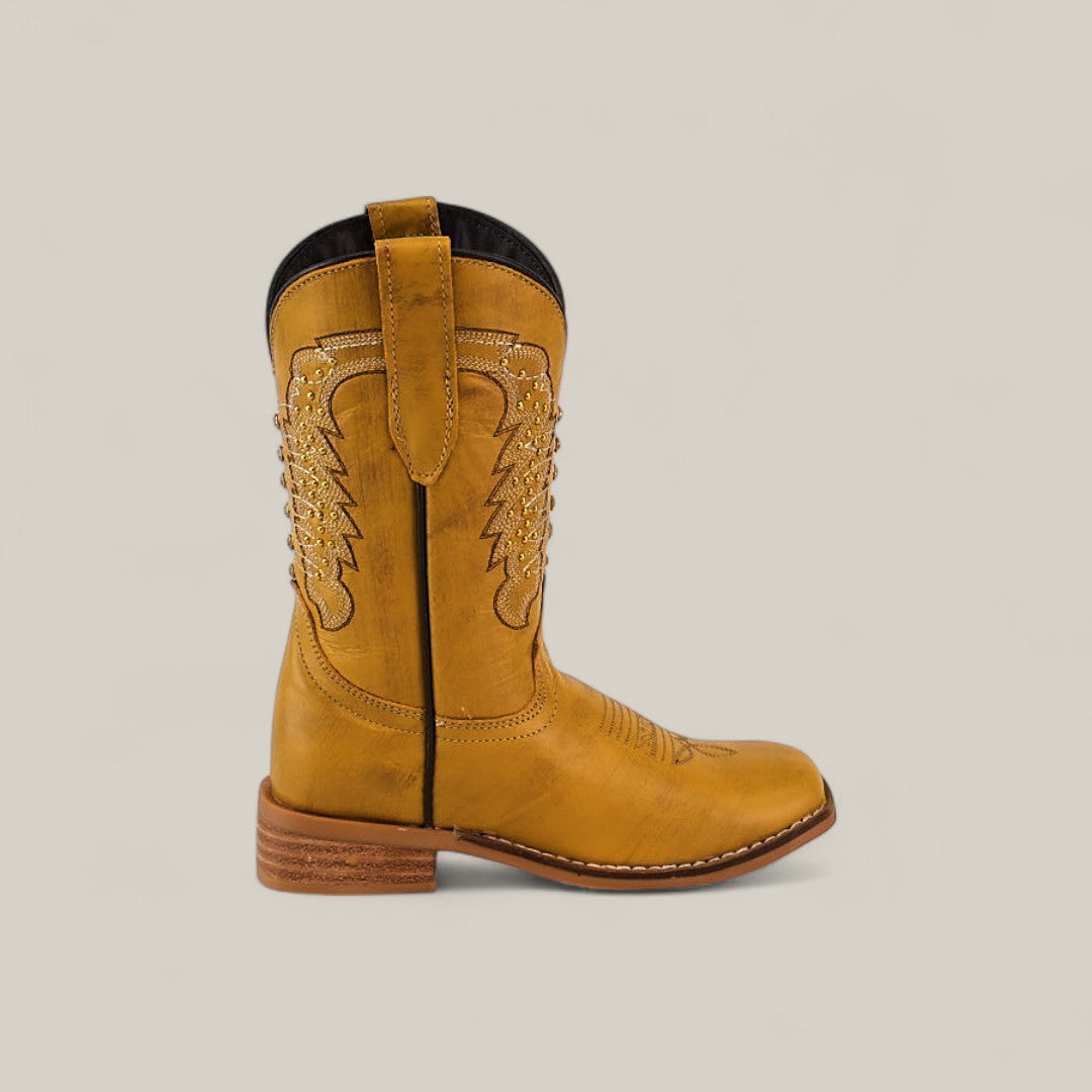 The Orion Yellow - Square Toe Kids Boots feature tan leather, decorative stitching, a pull strap, black lining, and a low wooden heel. Shown in profile against a plain light background.