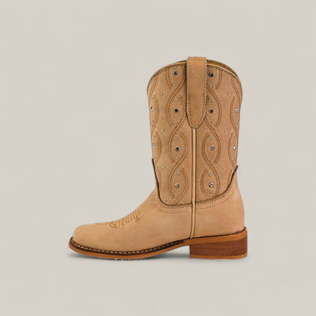 The Premiere Suede Bone - Square Toe Kids boot features premium tan suede, decorative stitching, small silver studs, a wooden heel, and a top loop, shown against a plain light background.