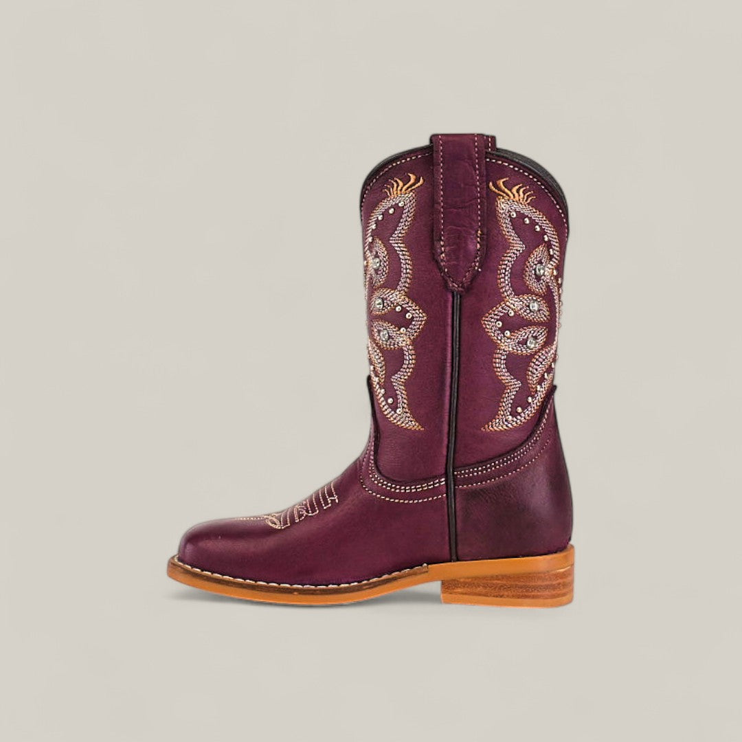 Blake Purple - Square Toe - Kids Boots: A single maroon cowboy boot with white and gold swirl stitching, a low wooden heel, and a light brown sole—combining trendy style and comfort on a neutral background.
