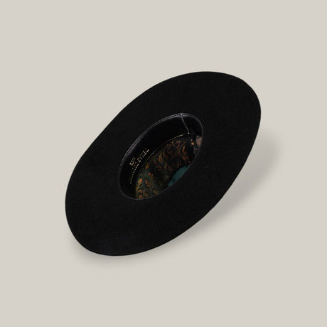 The 25X Grizzly - Black - TC Hat is a wide-brimmed luxury black hat with a decorative patterned inner band, shown from above on a plain beige background.