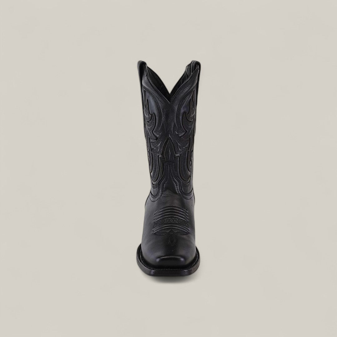 The Josie Full Black - Short Shaft - Narrow Square Toe boot is shown from the front, featuring decorative stitching and a classic black finish against a plain, light background for a chic look.