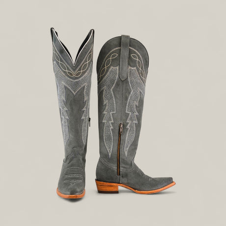 The Celine Gray - Tall Shaft - Snip Toe womens boots feature gray suede, decorative stitching, wooden heels, pointed toes, and a side zipper, shown against a plain beige background.