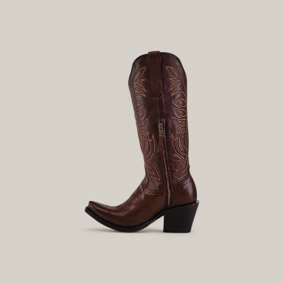 The Kellie Clayton Caramel Leather Sole boot features a tall shaft, snip toe, decorative stitching, angled heel, and side zipper. Shown in brown caramel leather against a plain light background.