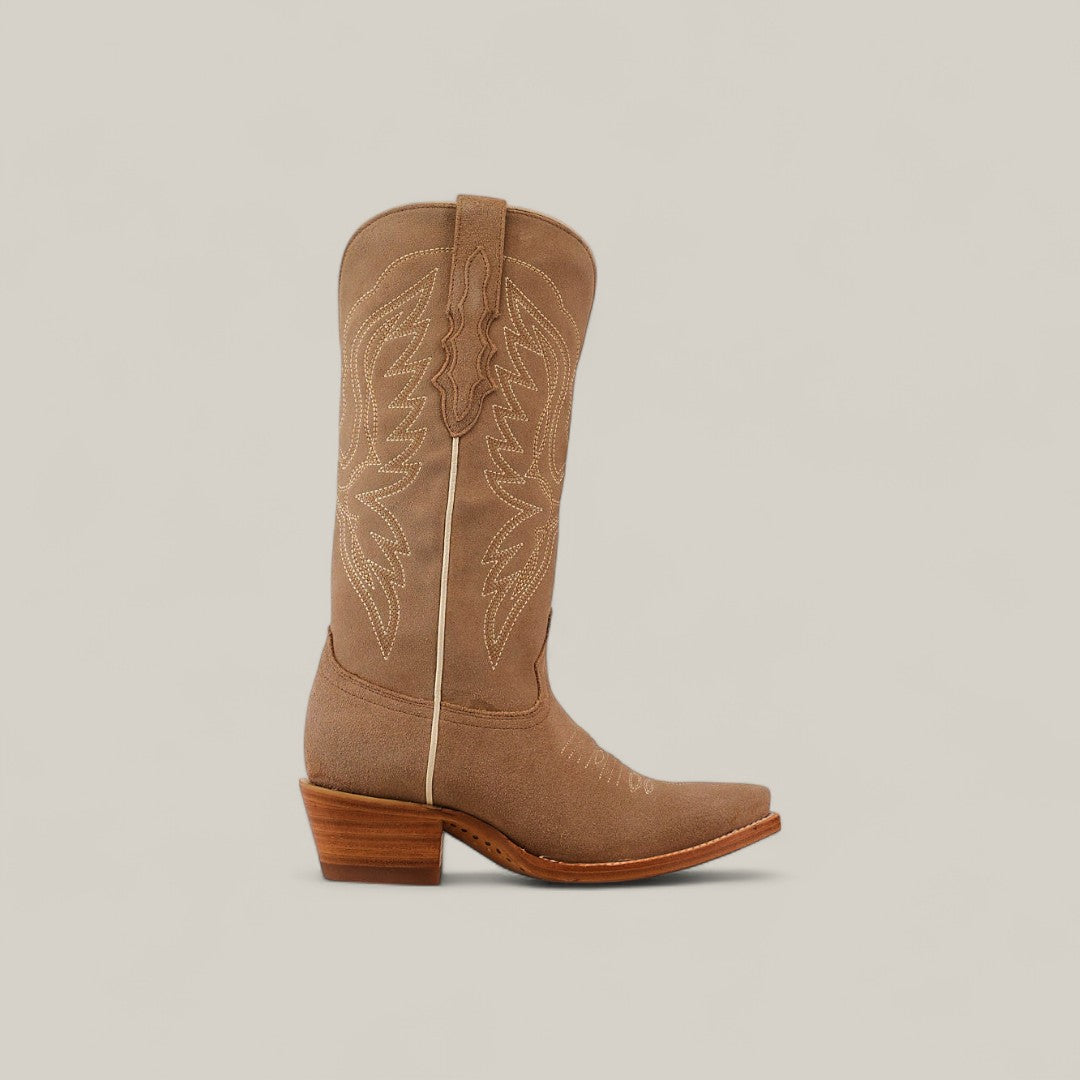 The Miranda Suede Khaki Leather Sole Boot features a mid shaft, snip toe, and decorative stitching. Shown in profile with a stacked wooden heel against a plain light beige background.