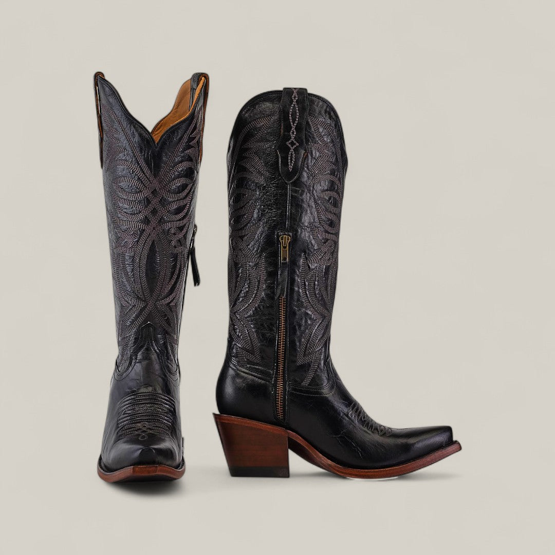 The Kellie Clayton Black Leather Sole boots feature a tall shaft, snip toe, and high wooden heels with intricate stitching and side zippers, displayed against a plain beige background.