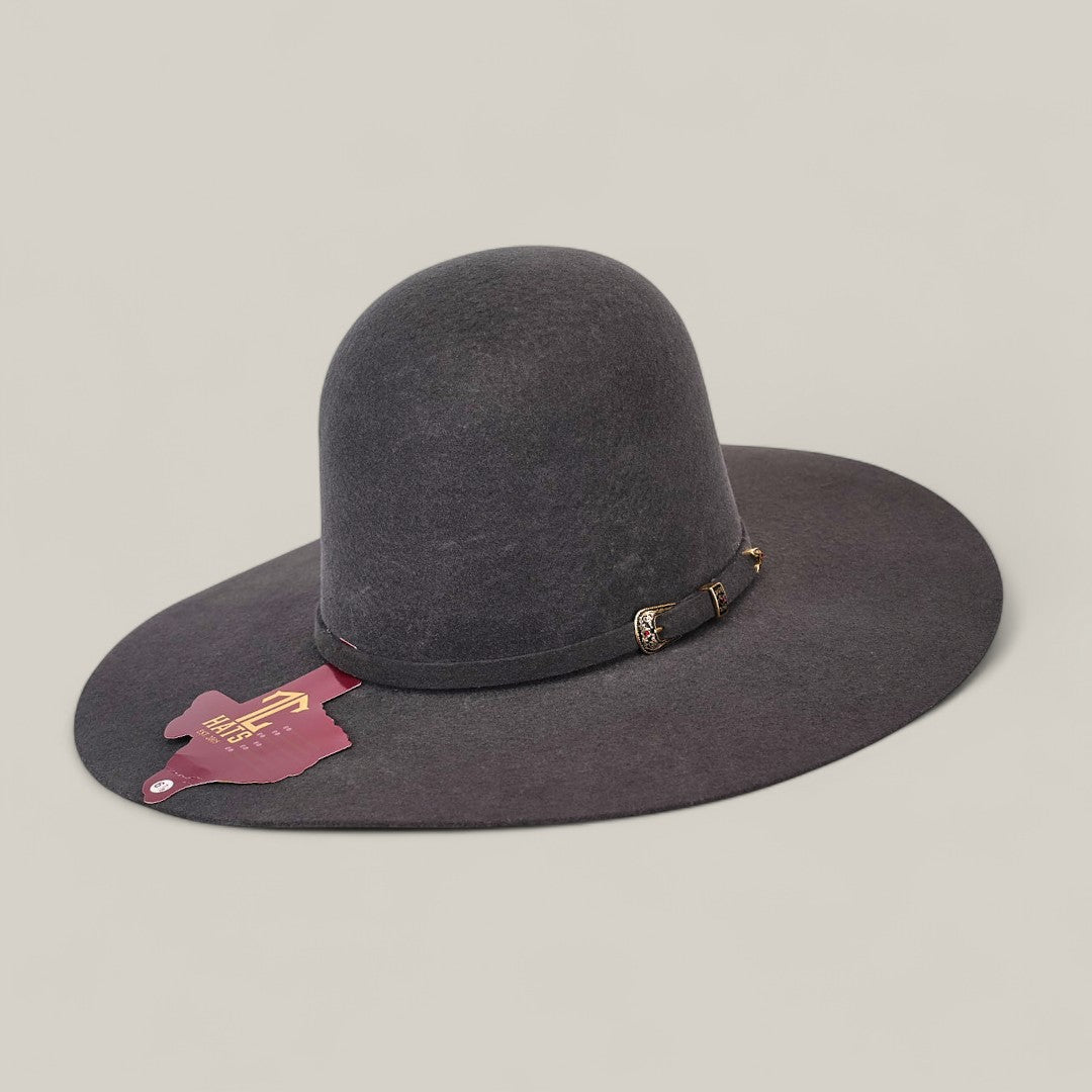 The 4X Gray - TC Hats is a wide-brimmed, dark gray felt Western hat with an open crown Texana style, decorative band and gold buckle, maroon tag on the brim, shown on a plain light background.