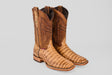 A pair of Exotic Caiman Belly - Antique - Square Toe boots with a brown, crocodile-like textured foot and decorative stitching on the shaft, shown against a plain gray background.