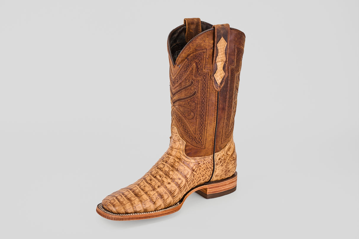 A single Exotic Caiman Belly - Antique - Square Toe boot featuring brown caiman leather with a textured, alligator-style pattern on the foot and detailed shaft stitching, displayed on a plain light gray background.