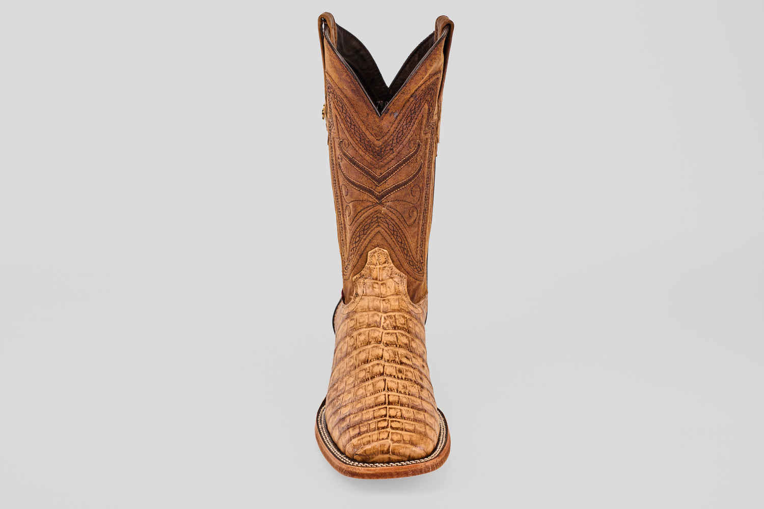 The Exotic Caiman Belly - Antique - Square Toe boot, featuring intricate shaft stitching and a textured alligator-patterned toe, is shown against a plain light gray background.