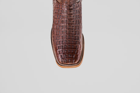 A close-up of the Exotic Caiman Horn Back - Brown - Square Toe boot shows its luxurious, exotic texture and distinctive square toe against a plain white background.