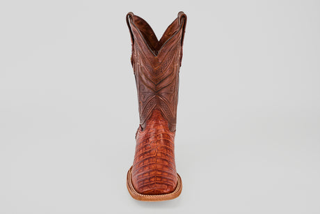 The Exotic Caiman Belly - Brandy - Square Toe boot, featuring detailed stitching and textured caiman leather, is shown from the front on a plain light gray background.