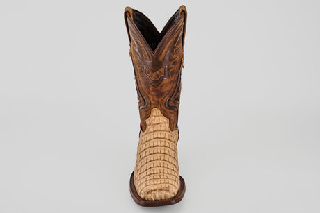 The Exotic Caiman Hornback - Orix - Rodeo Toe boot features a light tan, textured lower and a darker brown, intricately stitched upper, displayed front-facing against a plain white background.