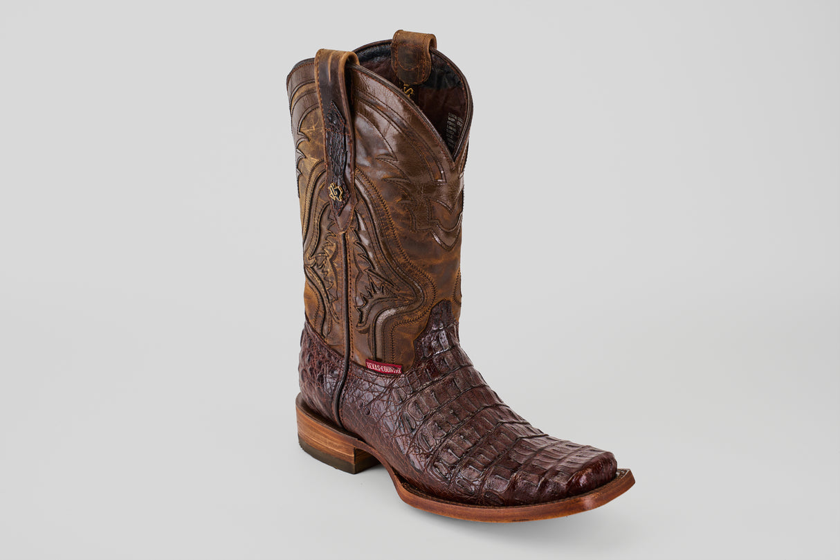 A single Exotic Caiman Hornback - Brown - Rodeo Toe cowboy boot featuring a brown leather upper with decorative stitching and a dark brown genuine caiman leather foot, shown against a plain light gray background.