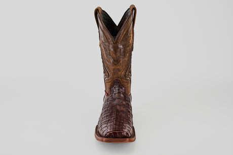 The Exotic Caiman Hornback - Brown - Rodeo Toe is a single cowboy boot made from genuine caiman leather, showcasing a crocodile-like texture and decorative upper stitching, displayed front-facing on a plain light background.