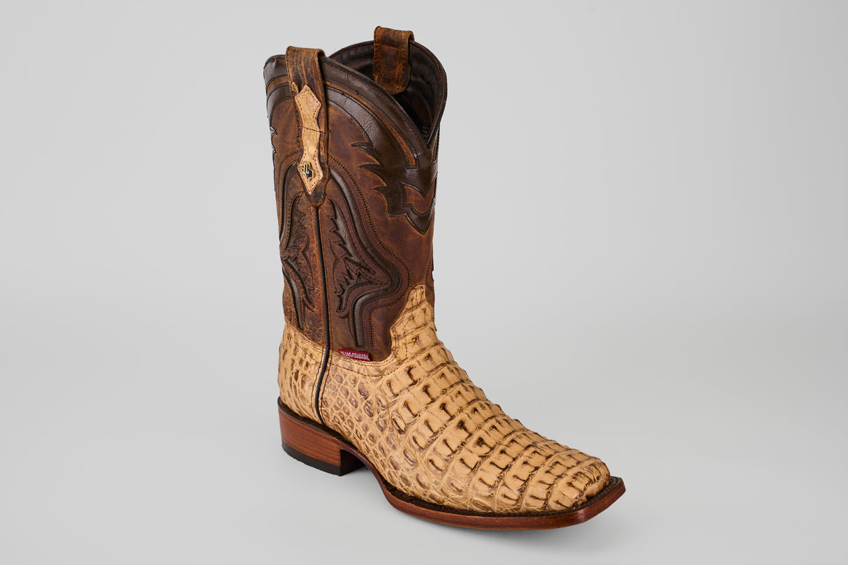 The Exotic Caiman Hornback - Antique - Rodeo Toe is a single cowboy boot with a light tan, textured caiman leather lower and a dark brown decorative upper, featuring a square toe and low wooden heel on a plain light background.
