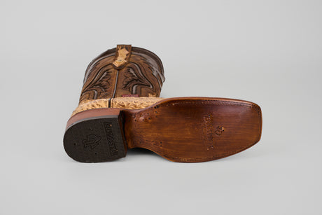 The Exotic Caiman Hornback - Antique - Rodeo Toe is a brown cowboy boot with a brown sole, made from exotic caiman leather and featuring an antique rodeo toe.