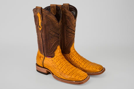 The Exotic Caiman Horn Back - Buttercup-Square Toe boots feature textured yellow caiman leather on the foot and detailed brown leather on the shaft, showcased against a light gray background.