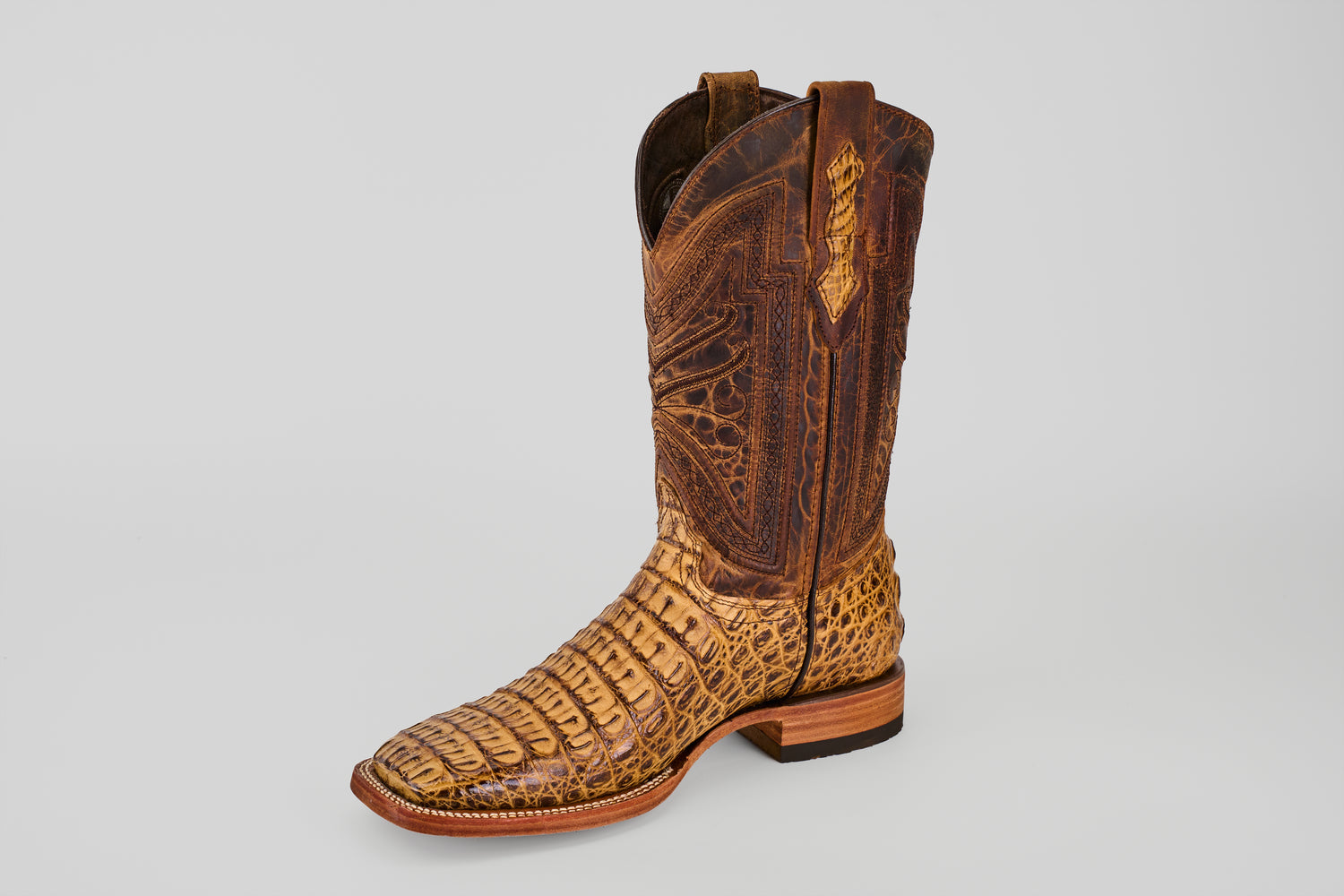 The Exotic Caiman Horn Back - Biza Camel - Square Toe boot features detailed stitching and a reptile-like textured leather in brown, shown against a plain light gray background—ideal for fans of exotic leather boots.