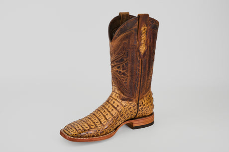 The Exotic Caiman Horn Back - Biza Camel - Square Toe boot features detailed stitching and a reptile-like textured leather in brown, shown against a plain light gray background—ideal for fans of exotic leather boots.