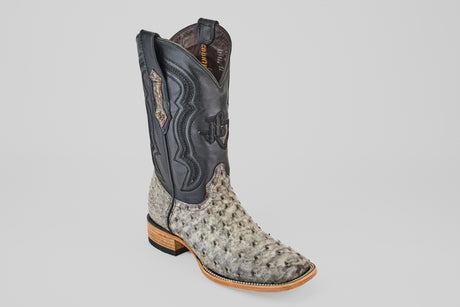 The Exotic Full Quill Ostrich - Nicotine - Square Toe men’s boot features a light gray ostrich lower, a black stitched upper shaft, and a wooden sole, showcased against a plain light background.