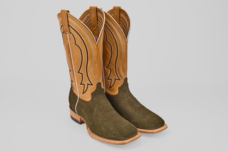 The Prime Suede Green Olive - Square Toe boots feature tan leather shafts, dark green olive suede lowers, decorative stitching, and a square toe design, displayed against a plain light background.