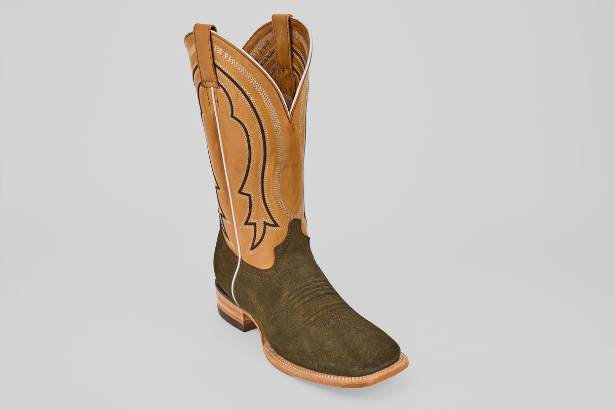 The Prime Suede Green Olive - Square Toe mens boot features a tan leather upper with decorative stitching and a dark olive green lower, shown on a light gray background for a classic square toe style.