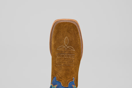 A close-up top view of the Gold Suede - Square Toe boot, crafted in brown suede with luxury white stitching on the square toe and blue ankle accents, set against a plain light background.