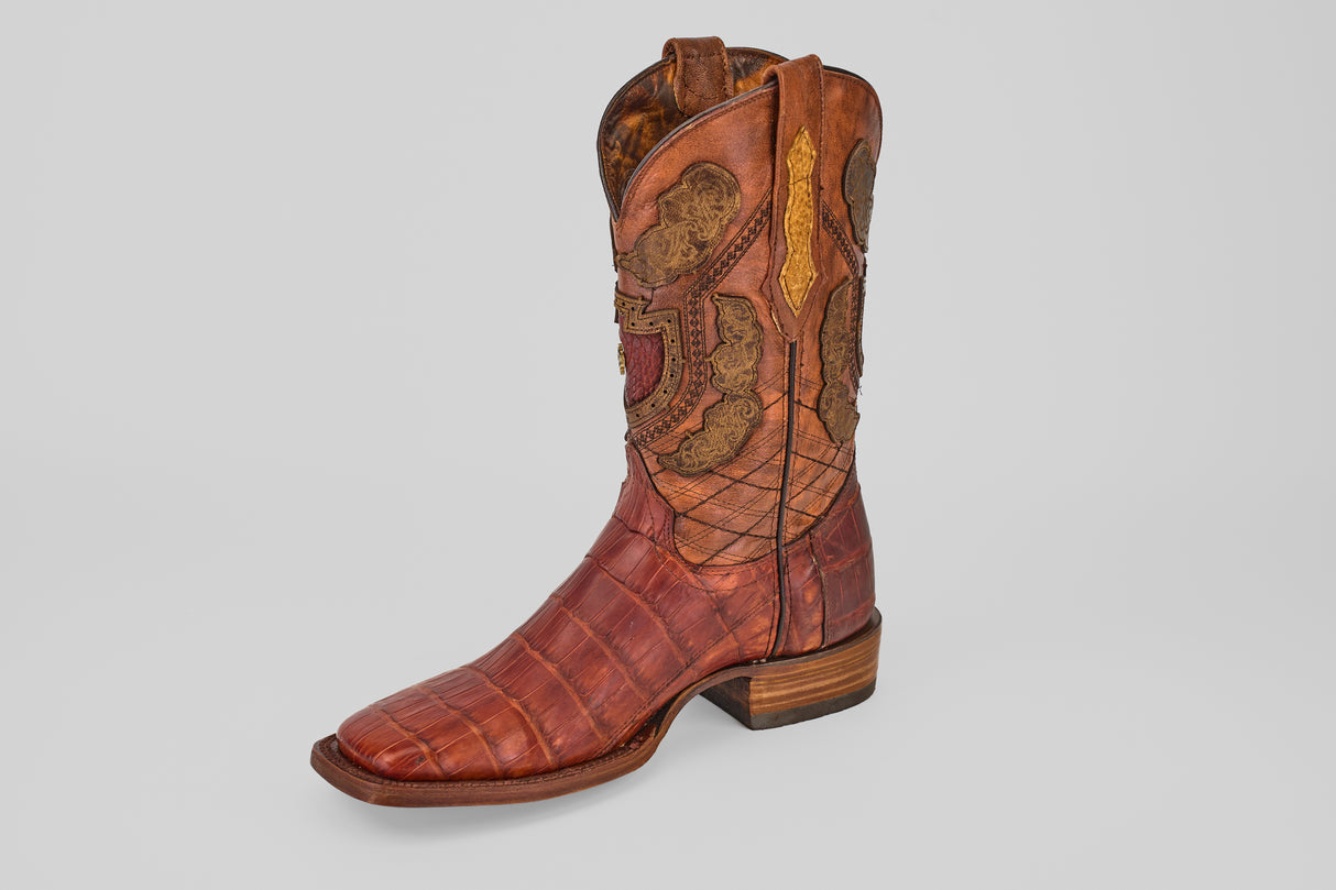 The Exotic Alligator Tail - Brick - Square Toe boot is made from genuine alligator leather, has detailed stitching, a low wooden heel, and is displayed on a light gray background.