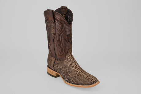 The Exotic Full Quilt Ostrich Leg - Matte Orix - Square Toe boot features a brown leather upper, a textured exotic quilted lower, and a light wooden heel and sole, displayed on a plain gray background.