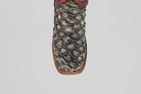 A detailed, top-down view of the Robinson - Newspaper - Square Toe boot highlights its textured Purarucu leather, brown trim, and white stitching—showcasing these distinctive handcrafted boots.