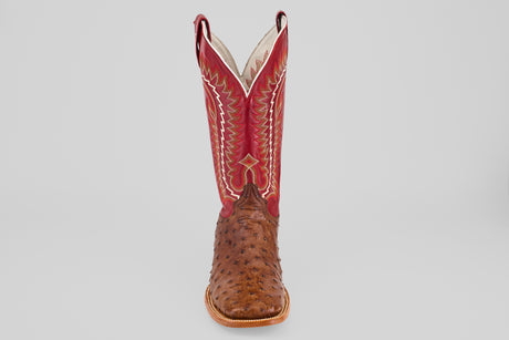 The Thompson - Red / Brown - Square Toe boot features brown ostrich leather, a tall red shaft with yellow and white stitching, and a square toe, displayed against a plain light gray background.