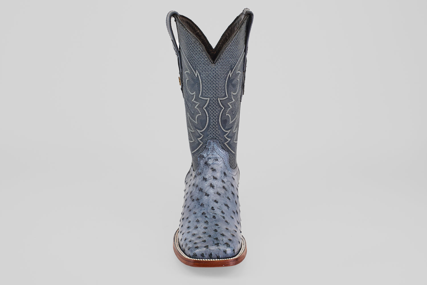 The Exotic Full Quilt Ostrich - Safari Gray - Square Toe boot is shown from the front, featuring decorative stitching, square toe, and full quill ostrich leather on a plain white background.