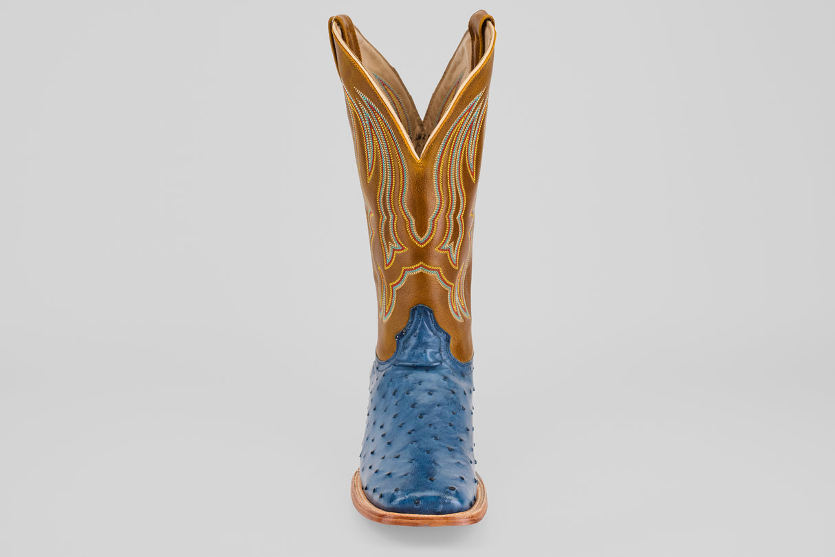 A Ridge - Blue - Square Toe cowboy boot from the Platinum Collection, with a tan shaft with yellow stitching and a blue textured ostrich foot, is photographed from the front against a plain light background.